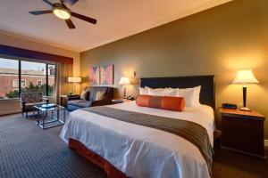 a bedroom with a large bed and a living room at Club Wyndham Harbour Lights in San Diego