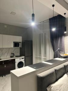 a kitchen with a counter top and a stove top oven at Apartments Velora in Kryvyi Rih