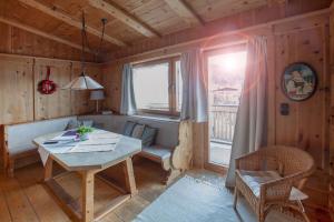 a dining room with a table and a window at Appartement Seebacher in Hochfilzen +48 photos