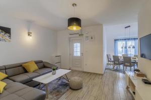 a living room with a couch and a table at Casa Maja in Brtonigla
