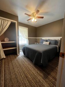 a bedroom with a bed and a ceiling fan at Papa Chubbys RV Resort in Sunrise Beach +41 photos