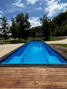 a swimming pool with blue water and a wooden deck at Papa Chubbys RV Resort in Sunrise Beach