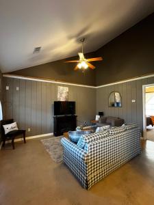 a living room with a ceiling fan and a couch at Papa Chubbys RV Resort in Sunrise Beach