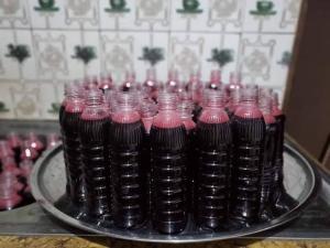 a group of pink and black glass vases on a table at Classic Hotel by TWM in Ibadan