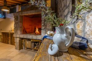 a vase sitting on a wooden table in front of a fireplace at Villa 72 Crikvenica Riviera in Bribir