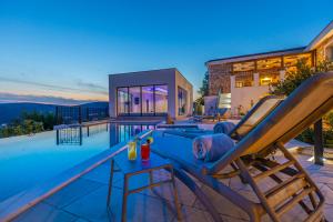 a villa with a swimming pool and a house at Villa 72 Crikvenica Riviera in Bribir