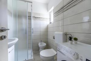 a white bathroom with a toilet and a sink at Casa Maja in Brtonigla +12 photos