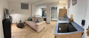a living room with a couch and a bed at Pendler Montagewohnung Kandern, Lörrach, Basel D,CH, FR in Holzen