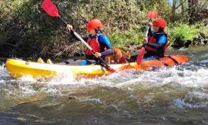 two people in a kayak on a river at Casa Rural Ivanrey in Ivanrey