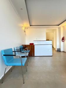 a room with chairs and a table and a counter at Sacred Crown Suites in Naivasha