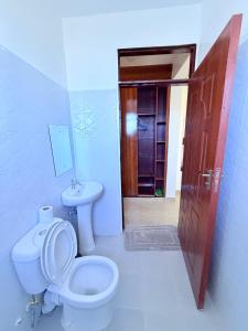 a bathroom with a toilet and a sink at Sacred Crown Suites in Naivasha +35 photos