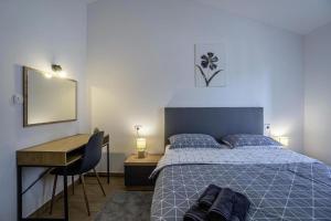 a bedroom with a bed and a desk and a desk at Casa Maja in Brtonigla
