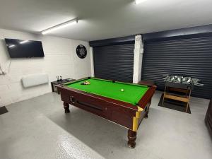 a room with a pool table in a room at The Farmhouse at Moss Bank Farm in Wrexham
