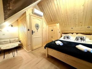a bedroom with a bed in a wooden room at Apartament Bioło Izba in Czerwienne +39 photos