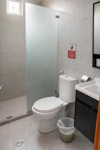 a bathroom with a toilet and a sink at Kinda Rum Luxury Camp in Wadi Rum