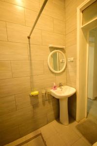 a bathroom with a sink and a mirror at Kigali Gem in Kigali +8 photos
