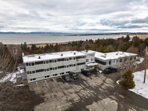 an aerial view of a building with a parking lot at Complexe la Falaise in Rivière-du-Loup