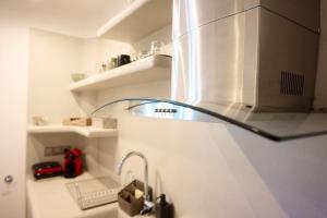 a kitchen with a sink with a stainless steel refrigerator at Merovigli Suites in Mérikhas +40 photos