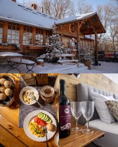 a bottle of wine on a table with food and wine glasses at Gospoda Dębowiec520 in Bielsko-Biała