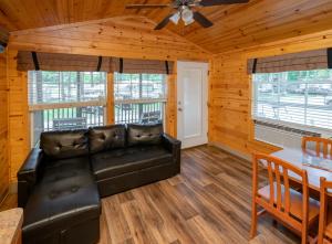 a living room with a couch and a table at Sun Outdoors Frontier Town in Berlin