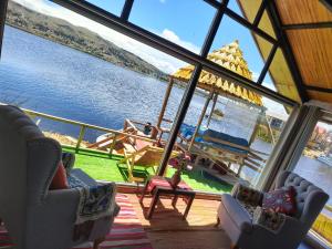 a room with a view of a boat in the water at INTI UTA titicaca in Puno