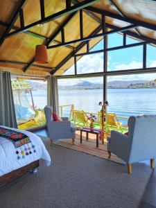 a bedroom with a view of the water at INTI UTA titicaca in Puno