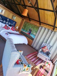 an overhead view of a room with two beds and a couch at INTI UTA titicaca in Puno