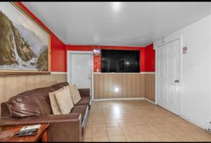 a living room with a couch and a tv at Large 3-Bedrooms/2-Bath Apt, One Block to Train in Brooklyn