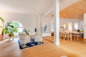 a dining room and living room with a table and chairs at Antonius Art-Loft in Waldshut-Tiengen