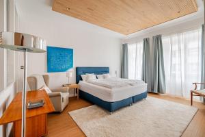 a bedroom with a bed and a chair and a couch at Antonius Art-Loft in Waldshut-Tiengen
