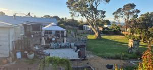 a backyard with a gazebo and a house at Hidden gem cheap and affordable in Te Kopuru