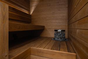 a sauna with a stack of logs in it at Rinneköngäs - Ruka-Pyhä 2x SKIPASS included - Free Skibuss Doorstep - Renovated in Ruka