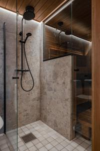 a bathroom with a shower with a glass door at Rinneköngäs - Ruka-Pyhä 2x SKIPASS included - Free Skibuss Doorstep - Renovated in Ruka