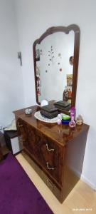 a wooden dresser with a mirror on top of it at Wohnung in der Ruhr Witten in Witten