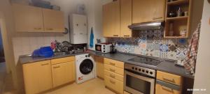 a kitchen with wooden cabinets and a dishwasher at Wohnung in der Ruhr Witten in Witten
