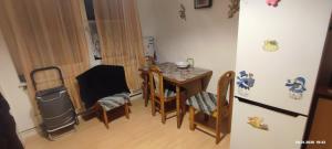 a kitchen with a table and chairs and a refrigerator at Wohnung in der Ruhr Witten in Witten +10 photos