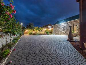 a stone driveway in front of a house at night at Lilla-Bett Self Catering Mossel Bay in Mossel Bay
