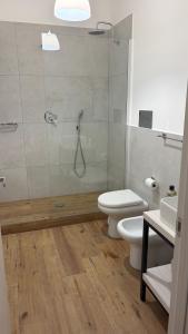 a bathroom with a shower and a toilet and a sink at Tra Mare e Mito in Agrigento +36 photos