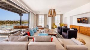 a living room with a large couch and chairs at Hotel El Ganzo - Adults Only in San José del Cabo