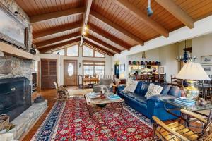 a living room with a blue couch and a fireplace at Peaks & Pines Escape in Beech Mountain
