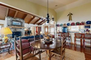 a kitchen and living room with a table and a couch at Peaks & Pines Escape in Beech Mountain