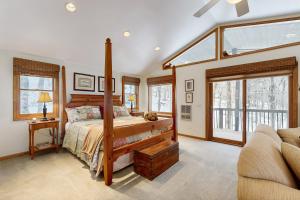 a bedroom with a bed in a room with windows at Peaks & Pines Escape in Beech Mountain