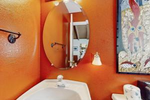 an orange bathroom with a sink and a mirror at Peaks & Pines Escape in Beech Mountain +19 photos