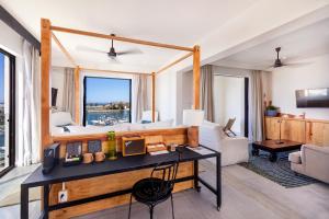 a living room with a desk and a couch at Hotel El Ganzo - Adults Only in San José del Cabo
