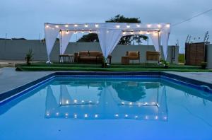 a swimming pool with a gazebo and a pool at Mjee's Guest House in Ulundi