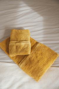 a pile of towels sitting on top of a bed at Habitación en vivienda compartida con baño privado in Santullán +8 photos