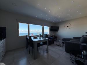 a living room with a table and a couch at MAXIM APARTMENT in Heraklio