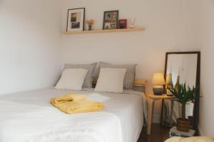 a bedroom with a bed with a towel on it at Habitación en vivienda compartida con baño privado in Santullán