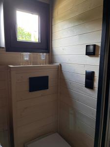 a bathroom with a toilet and a window at Tiny House Barujec in Brenna +19 photos