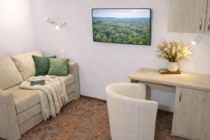 a living room with a couch and a table at HOME Apart-Hotel Vilnius in Vilnius